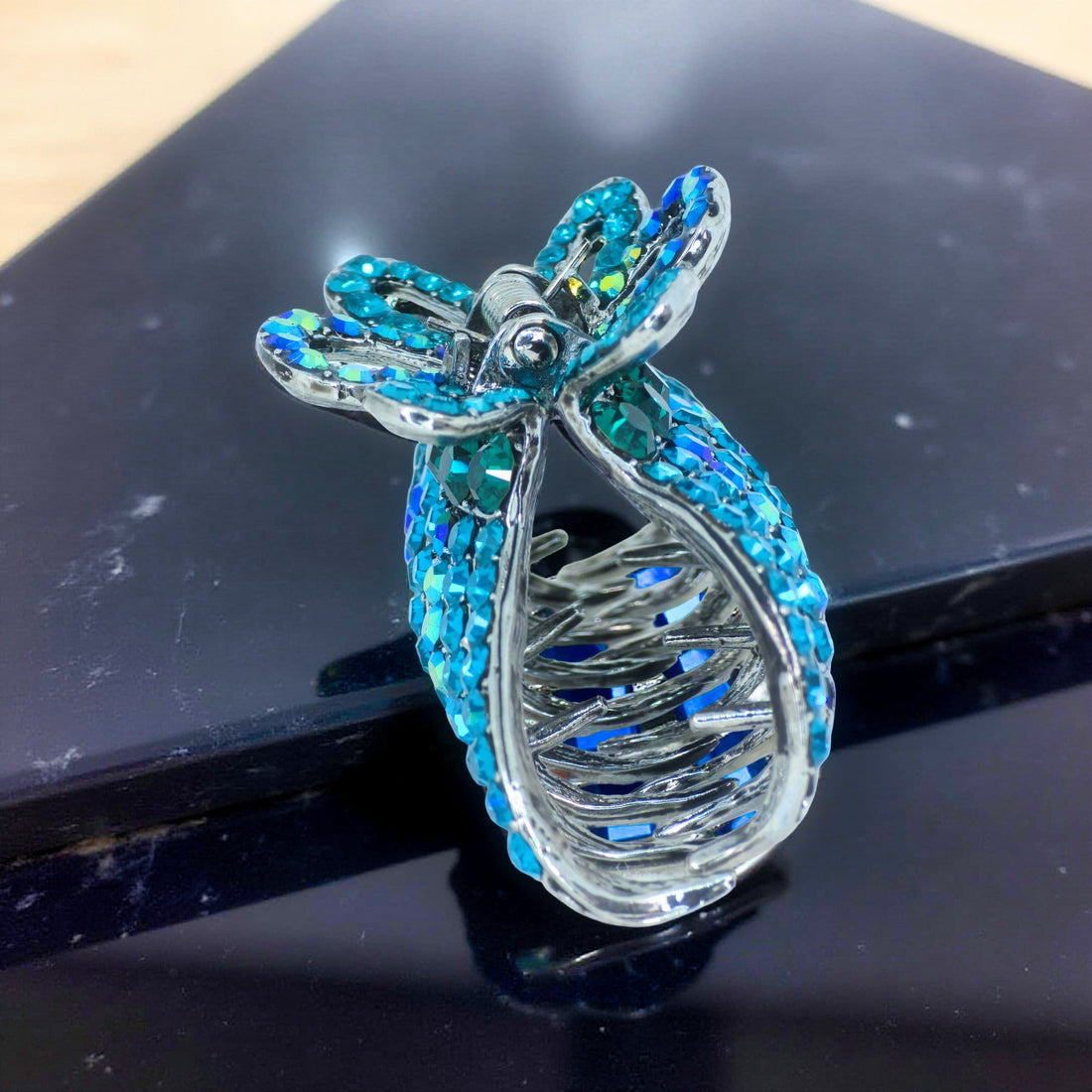 Side view of Haerime Aurefan Arc Claw – Blue Zircon version showing curved handle design