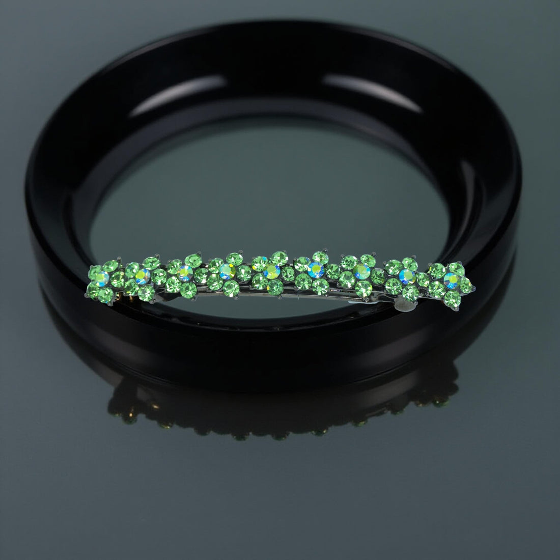 : Haerime Aureflor Arc Barrette in Green close-up – floral rhinestone clusters on oxidized silver base
