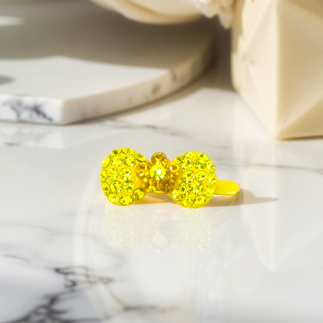 Haerime Chérie Clip in Yellow – close-up showing curved shape, pavé-set rhinestones, and reflective enamel finish