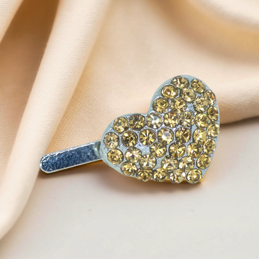Haerime CoeurClip in Amber – close-up showing curved sculpted form and pavé rhinestone surface