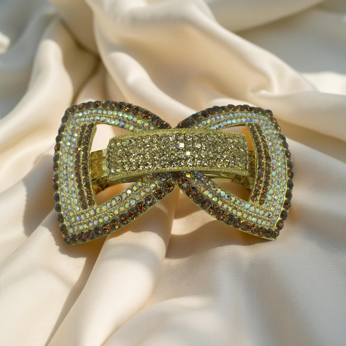 Amber version of Haerime Ecliptique Bow – warm gold-tone couture barrette with reflective crystal finish