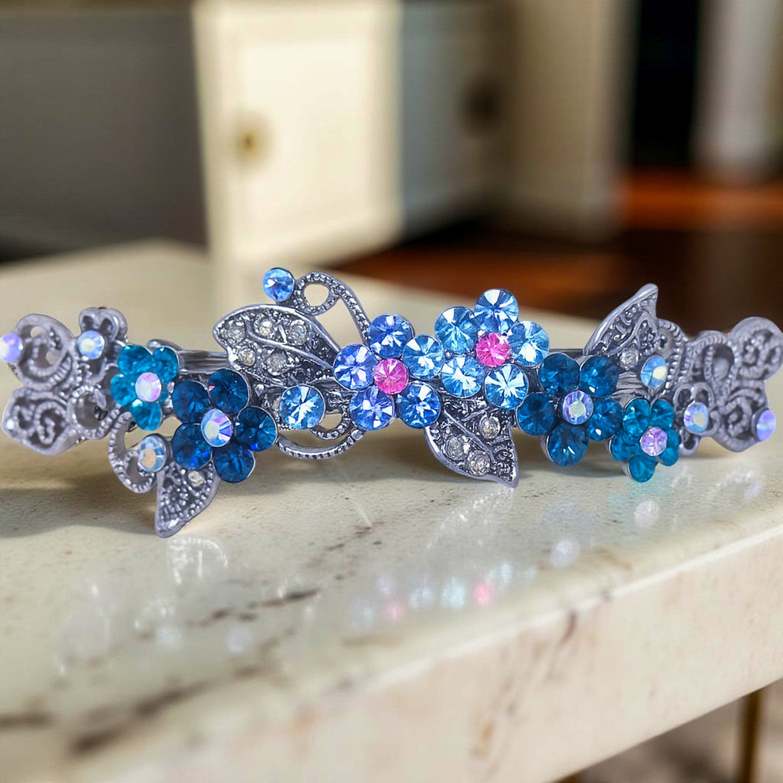 : Haerime Elysia Garland Barrette in Blue close-up – hand-set clustered crystals, leaf filigree, and micro pavé petals