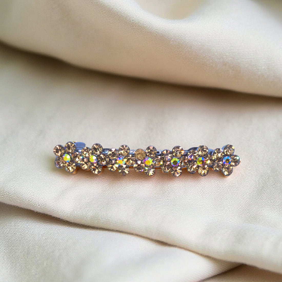 Amber version of Haerime FloraDot Row – warm-toned crystal floral mini barrette with curved silhouette
