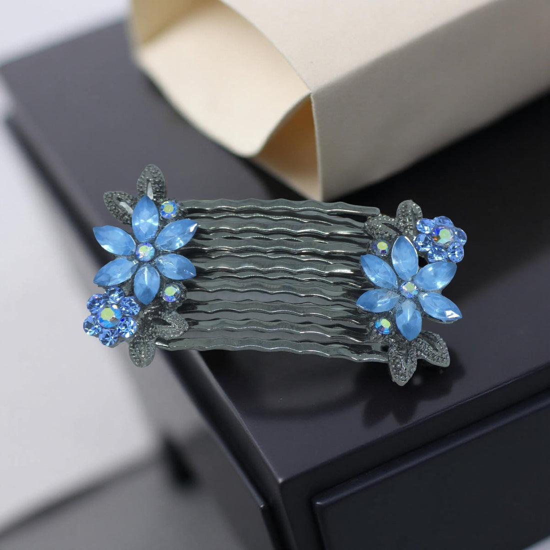 Blue version of Haerime Florelle Petite Combs – floral pair combs with marquise petals and antique base