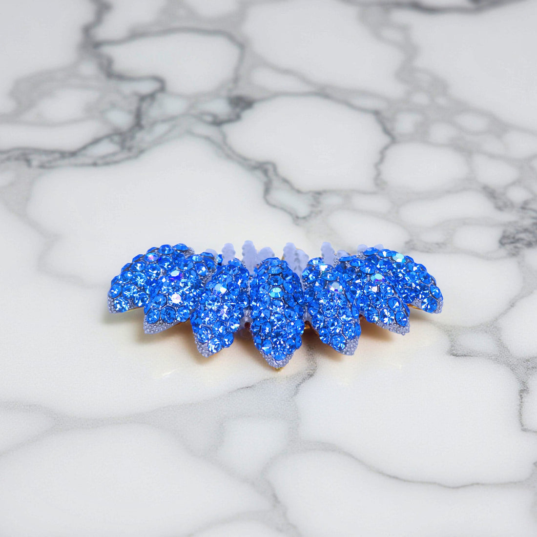 Haerime Gleamleaf Crown Comb in Blue – side vertical view showing arc shape and faceted petals