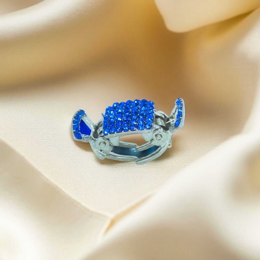 Haerime LumiClasp Mini in Blue – side angle showing layered curve and crystal-studded arms