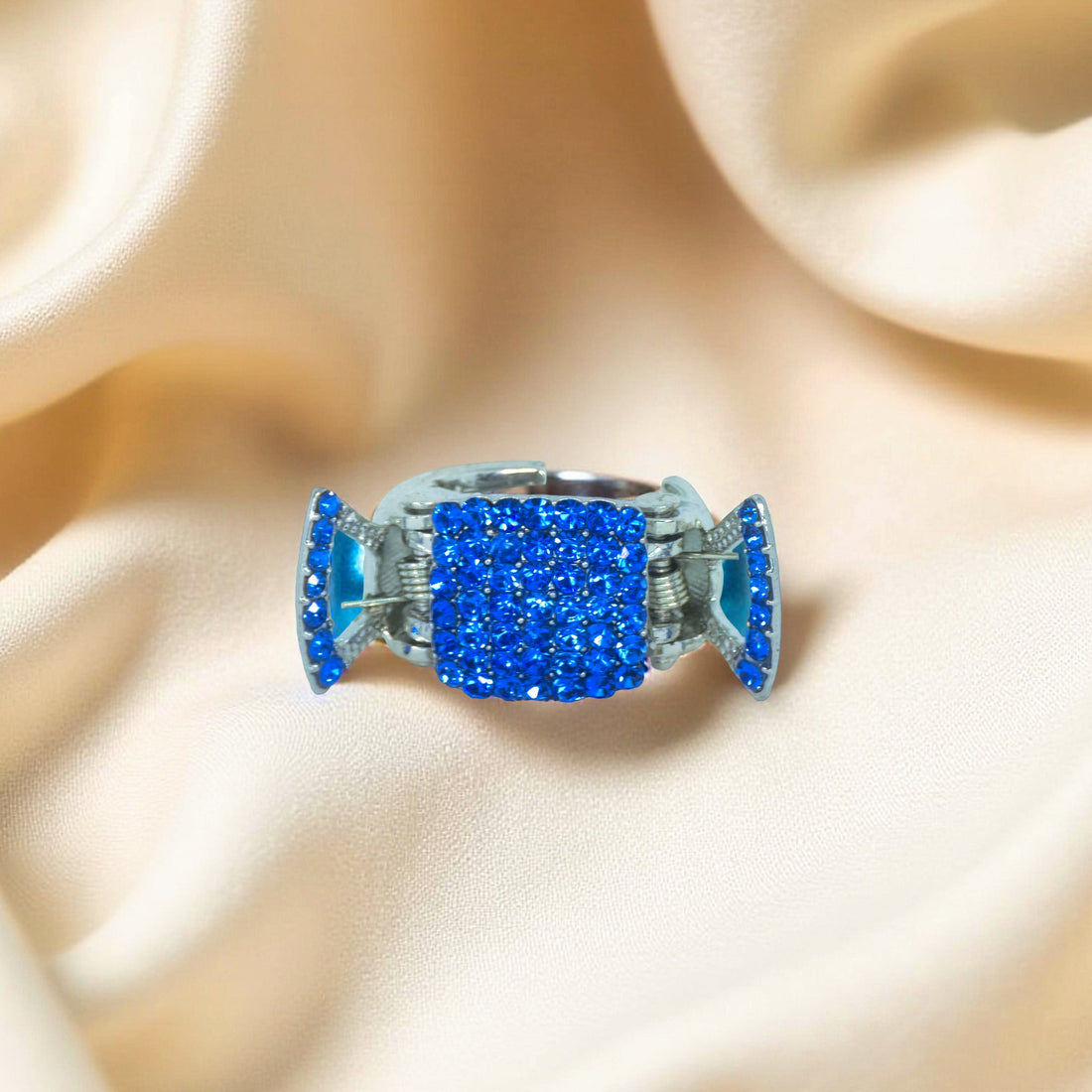 Haerime LumiClasp Mini in Blue – overhead top view highlighting deep cobalt crystal face and compact shape