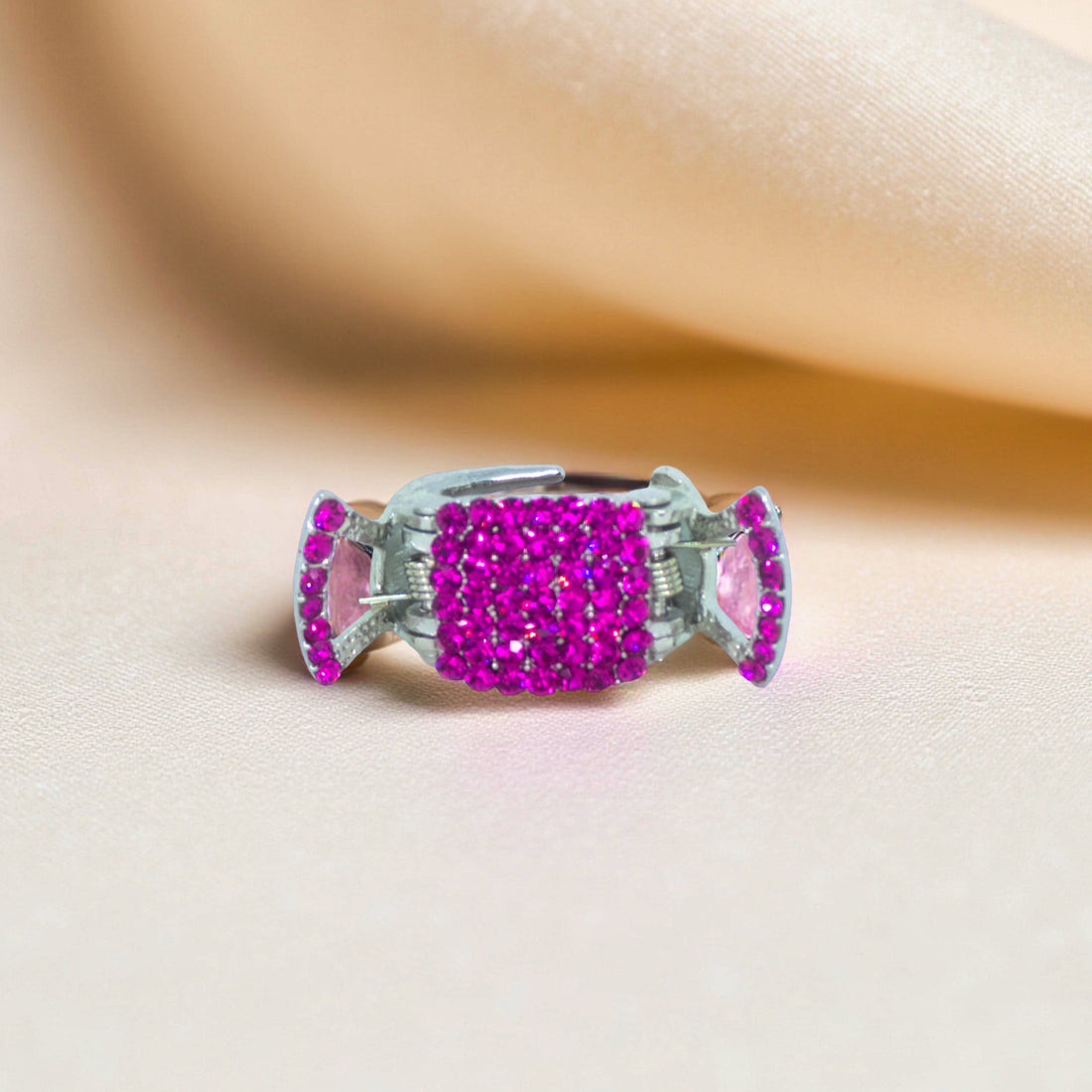 Haerime LumiClasp Mini in Fuchsia – top-down image of vivid pink crystal jaw clip on velvet backdrop