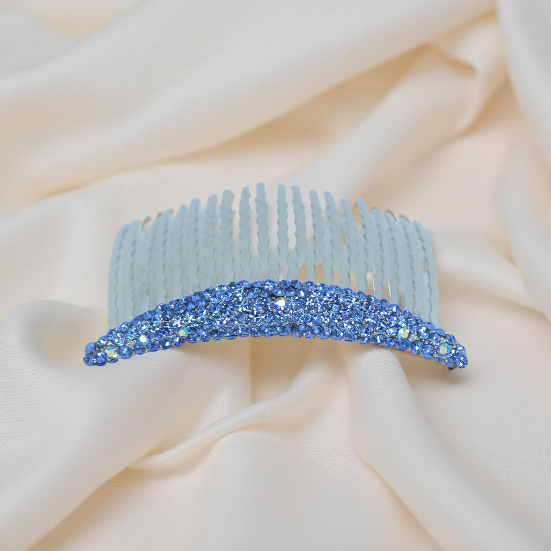 Haerime Lunoria Arch Comb in Blue – overhead image of sapphire-tone crystal arc with airy shine