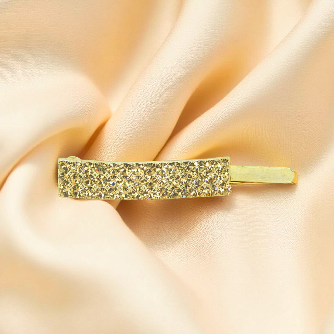 Haerime Magnetta Snap Clip in Amber – golden-hued crystals set in linear pavé on soft beige fabric