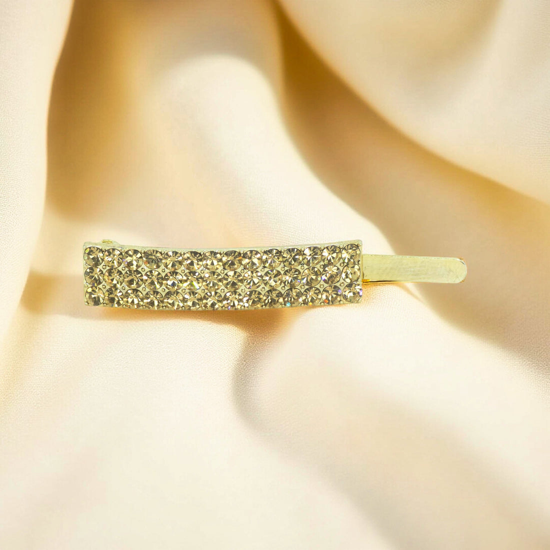 Haerime Magnetta Snap Clip in Amber – flat lay showcasing honey-toned crystals on gold base with warm light reflection