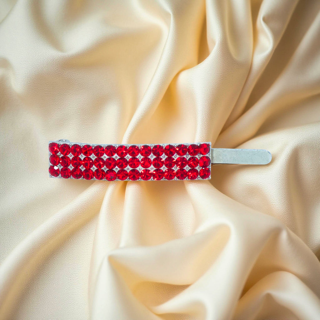 Haerime Magnetta Snap Clip in Red – top view showing vivid red crystal alignment on warm-toned satin