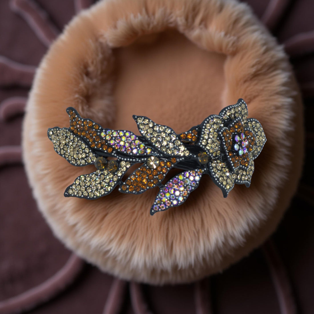 Haerime Midnight Bloom Barrette in Amber – crystal bloom arc in warm gold tones, captured on soft cream satin