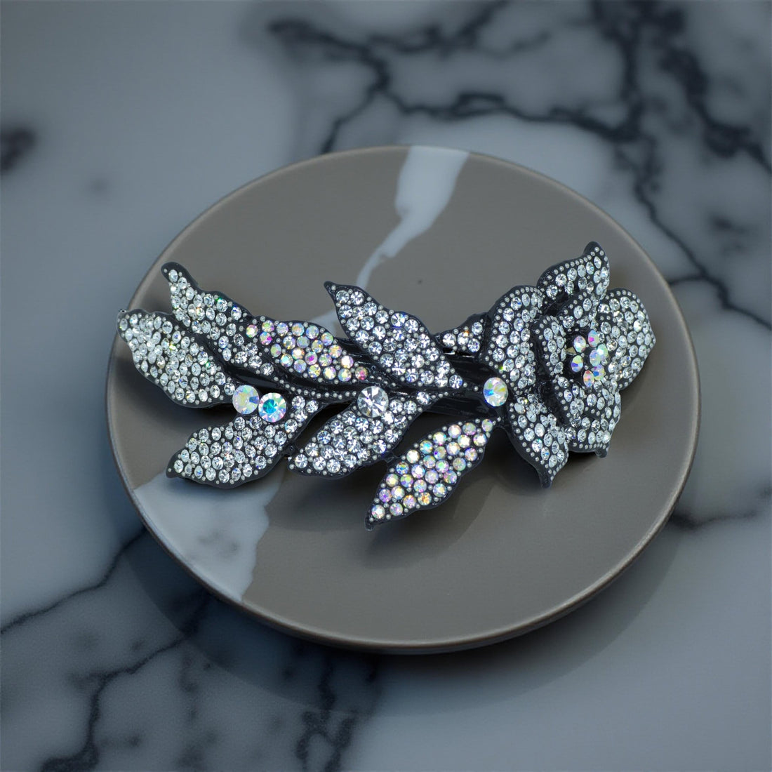 Haerime Midnight Bloom Barrette in Clear – shown on ivory satin, glowing with bridal crystal clarity and moonlit shape