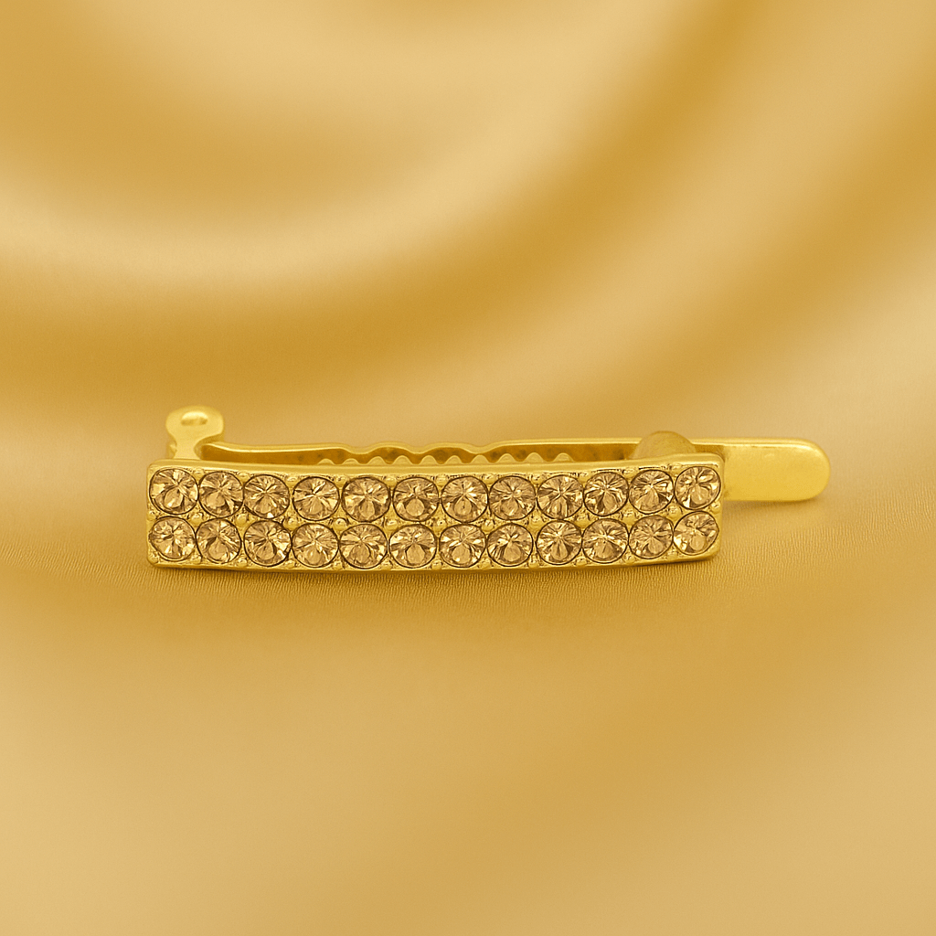 Haerime Minette Magnet Clip in Amber – golden pavé bar with warm light reflections, shown on pale gold satin