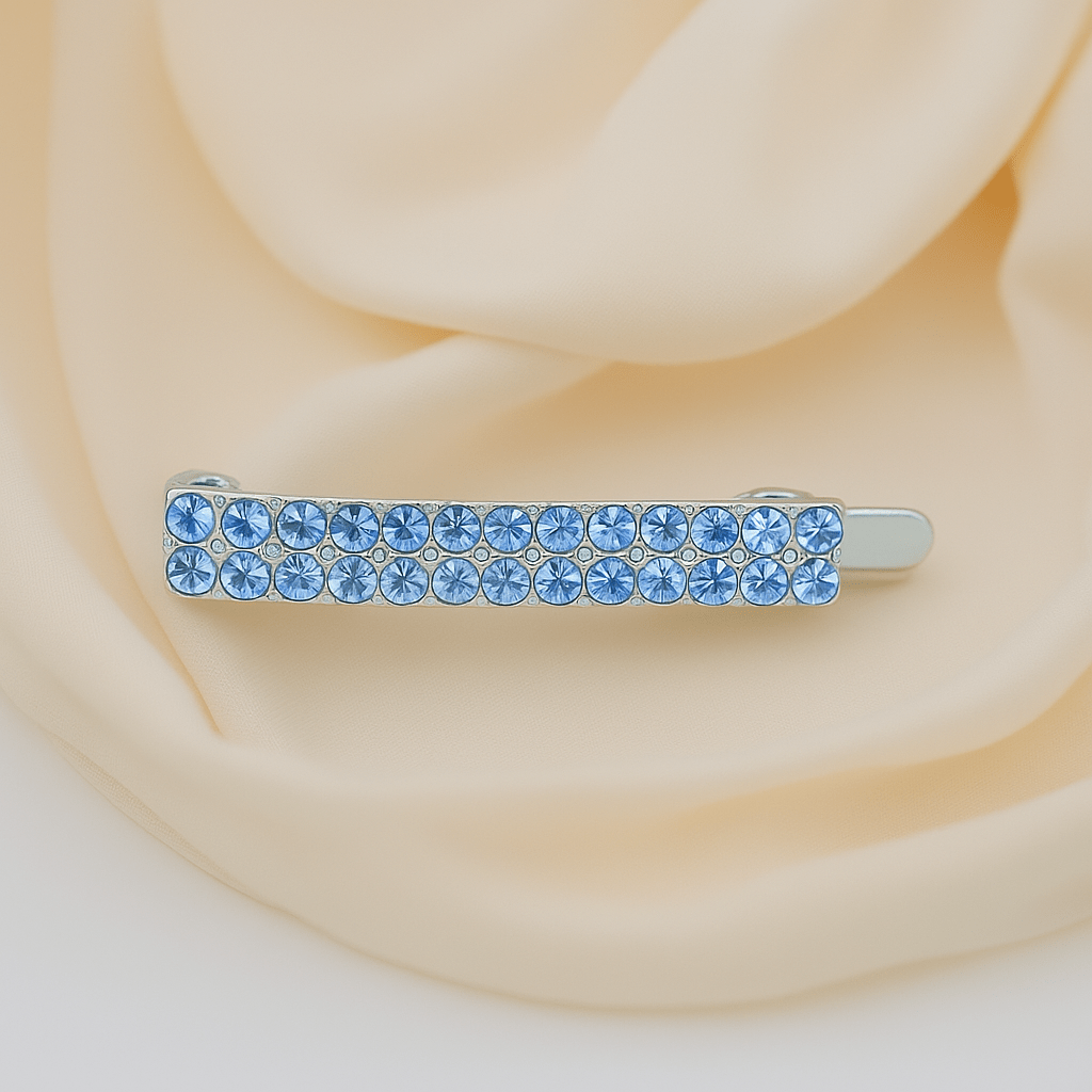 Haerime Minette Magnet Clip in Blue – close-up of bright blue pavé on silver-toned bar against soft ivory fabric
