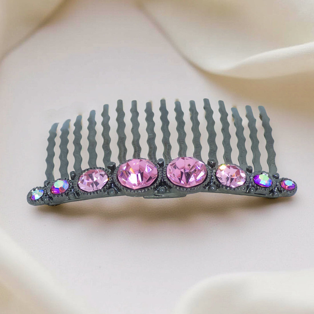 Haerime Ornette Classic Comb in Pink – blush crystal row centered on polished silver base, placed on cream satin