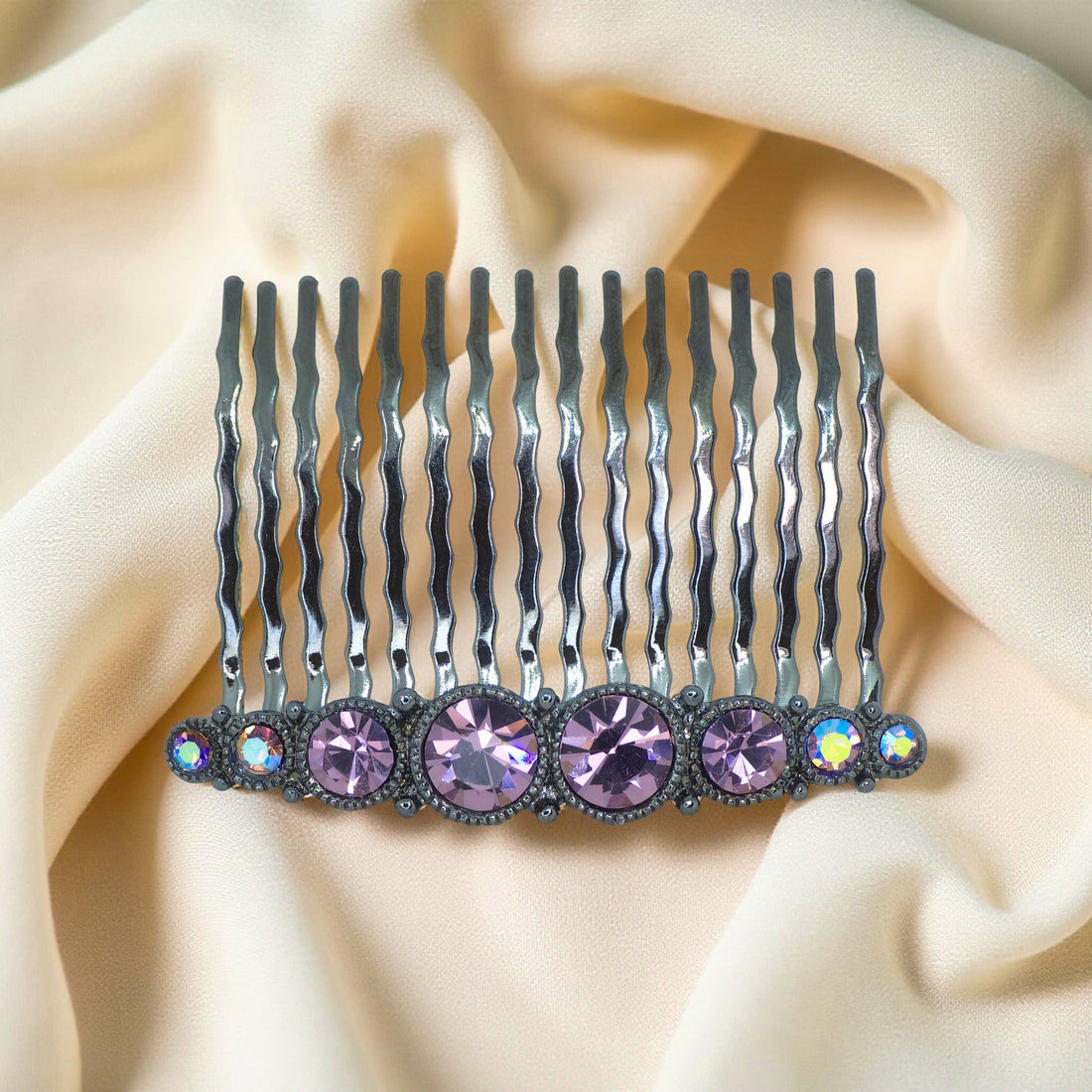 Haerime Ornette Classic Comb in Purple – top view of lilac-toned crystal comb with curved silver prongs, shown on neutral satin