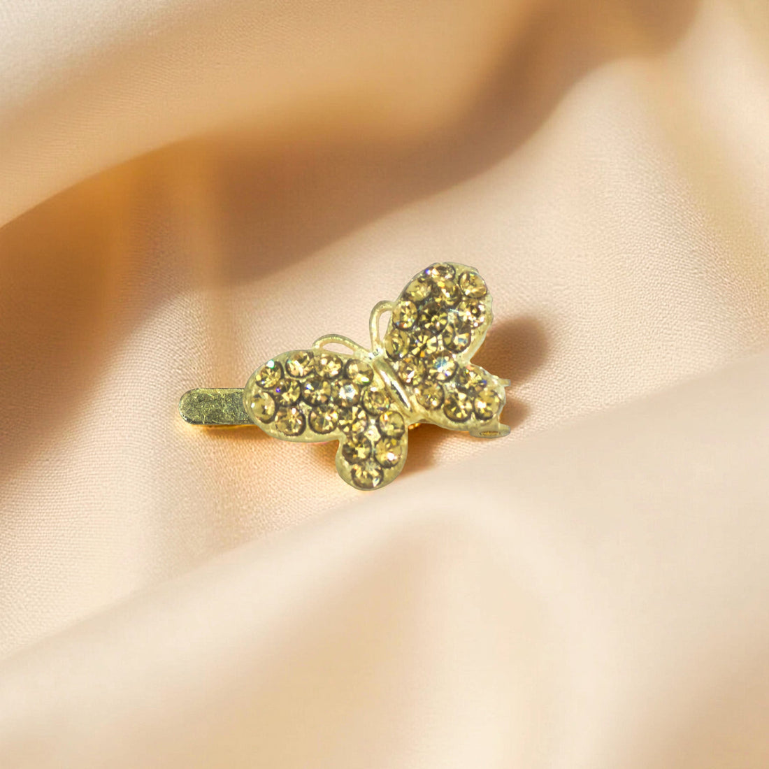 Haerime Papillon Éclat Clip in Amber – top view of golden-toned butterfly clip with amber pavé wings