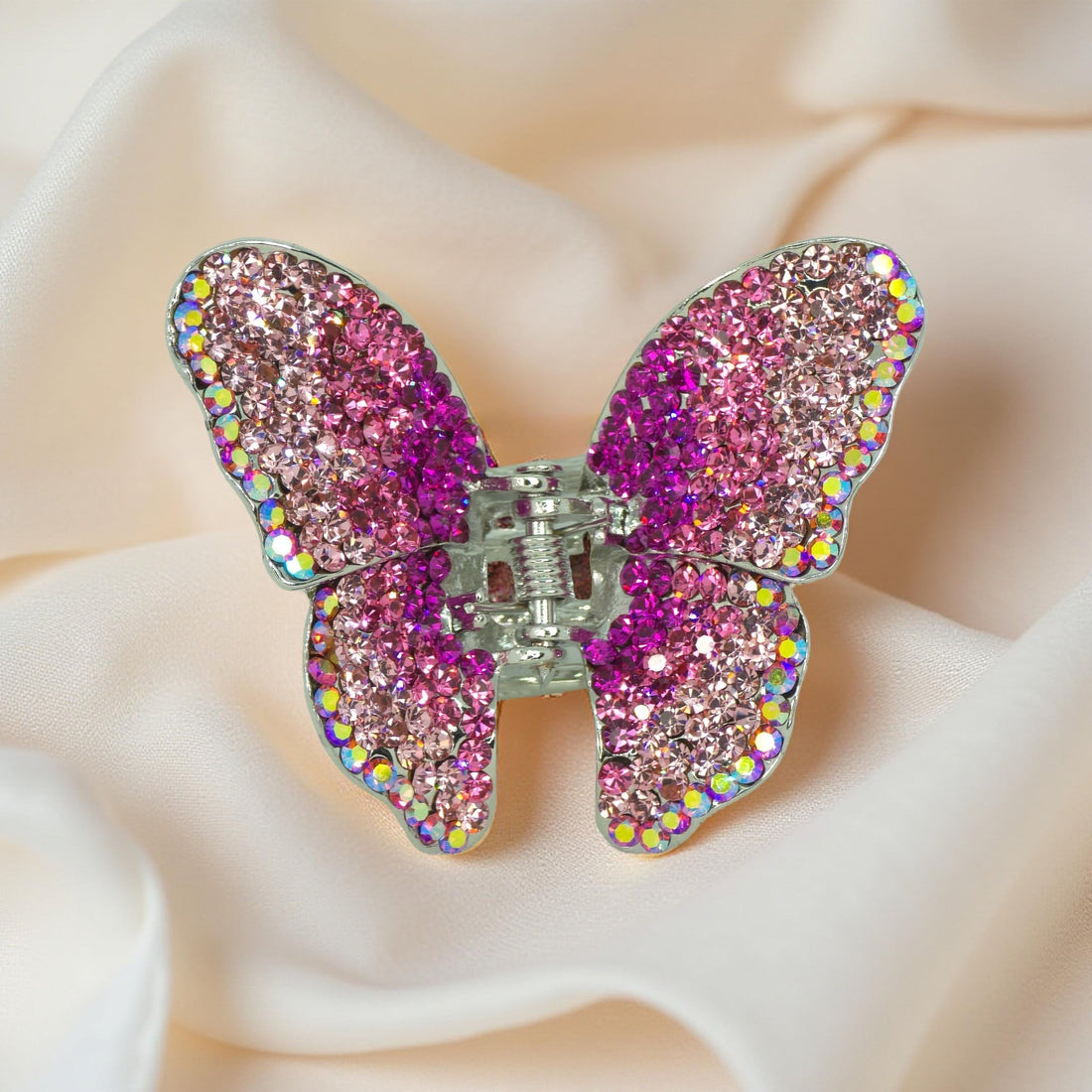 Haerime Papillora Mini Claw in Pink – pastel pink pavé wings centered on cream satin with soft sculptural glow