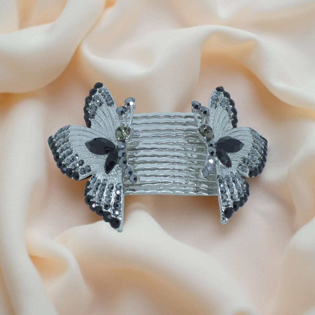 Haerime Papillora Twin Comb Set in Black – dual combs with jet pavé wings shown on matte black silk with minimalist lighting