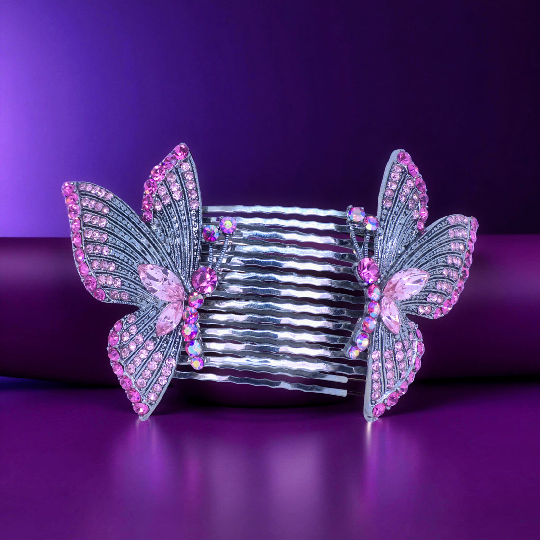 Haerime Papillora Twin Comb Set in Pink – soft blush butterfly combs placed on smooth champagne satin in diffused daylight