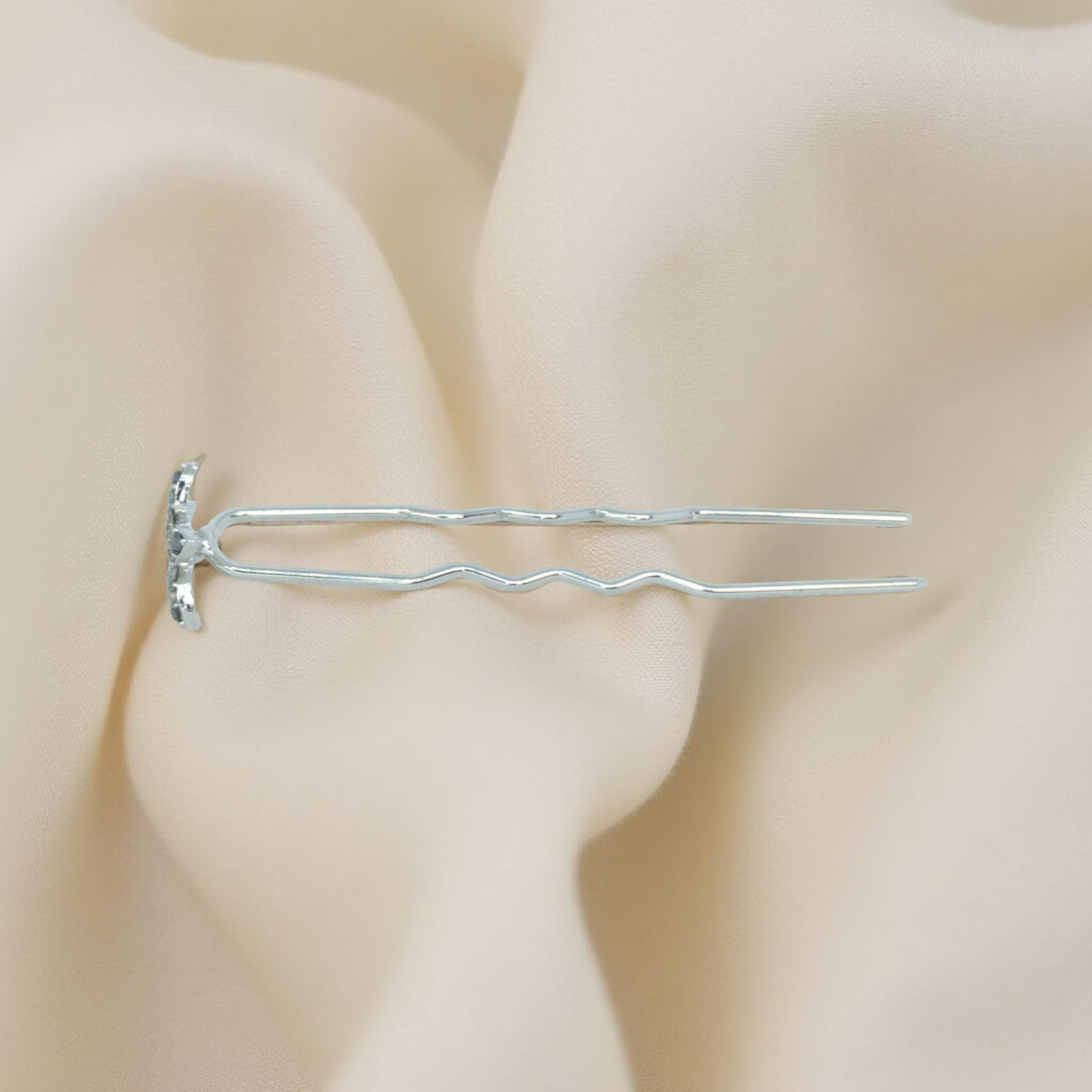 Haerime Petalight Hair Stick in Clear – side angle showing floral sparkle and silver stick glinting on velvet surface