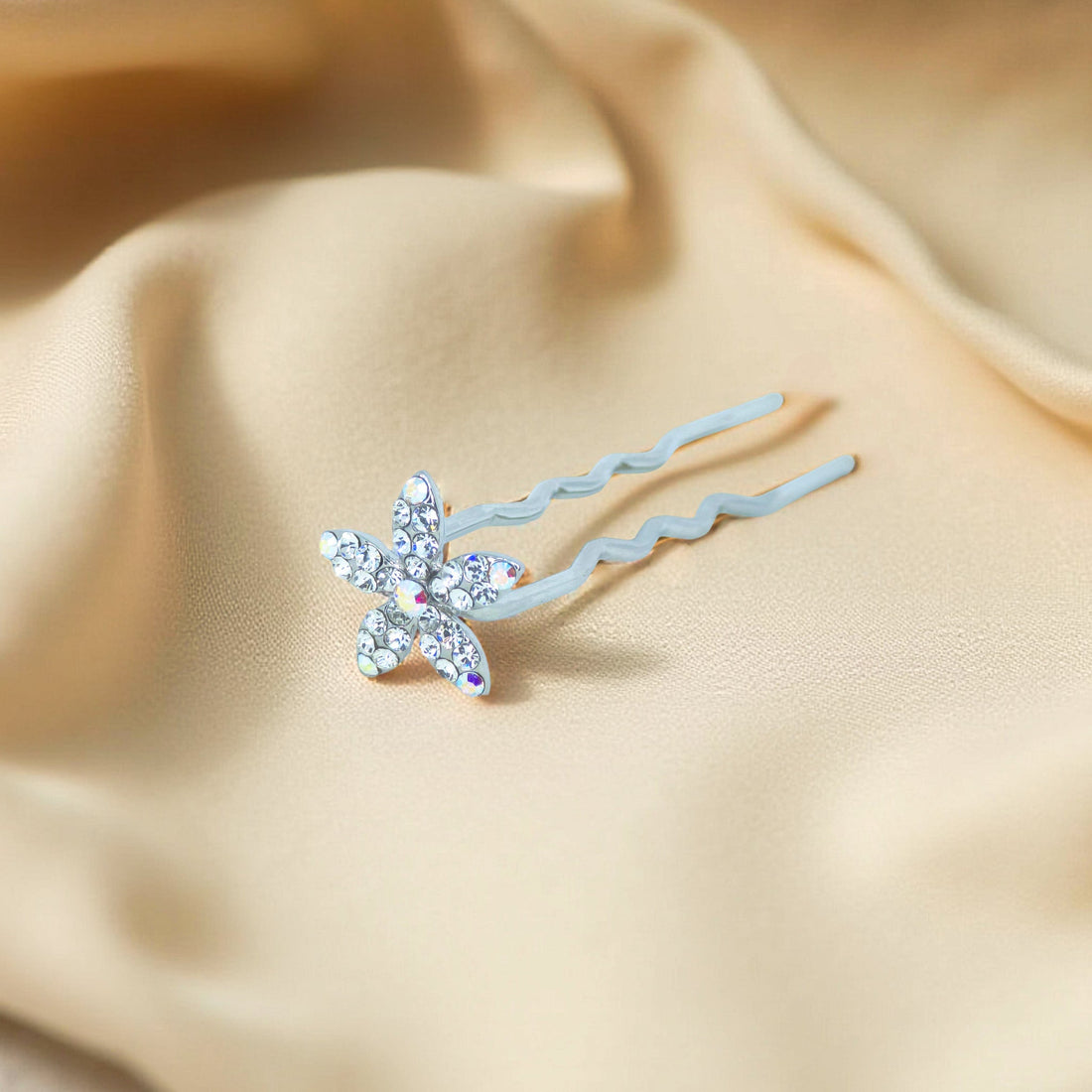Haerime Petalight Hair Stick in Clear – top view of radiant white crystal flower resting on silky pouch
