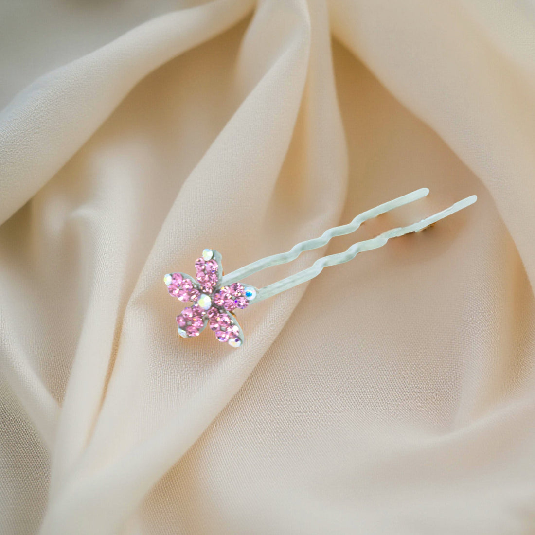 Haerime Petalight Hair Stick in Pink – top-down view of delicate rose crystal pin resting on neutral background