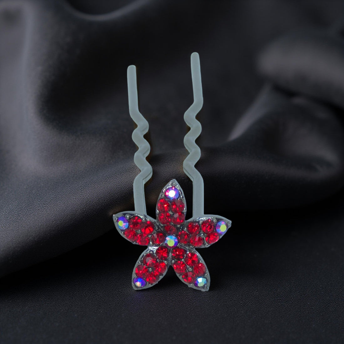 Haerime Petalight Hair Stick in Red – close-up capturing red pavé petals and smooth pin shape on pale satin