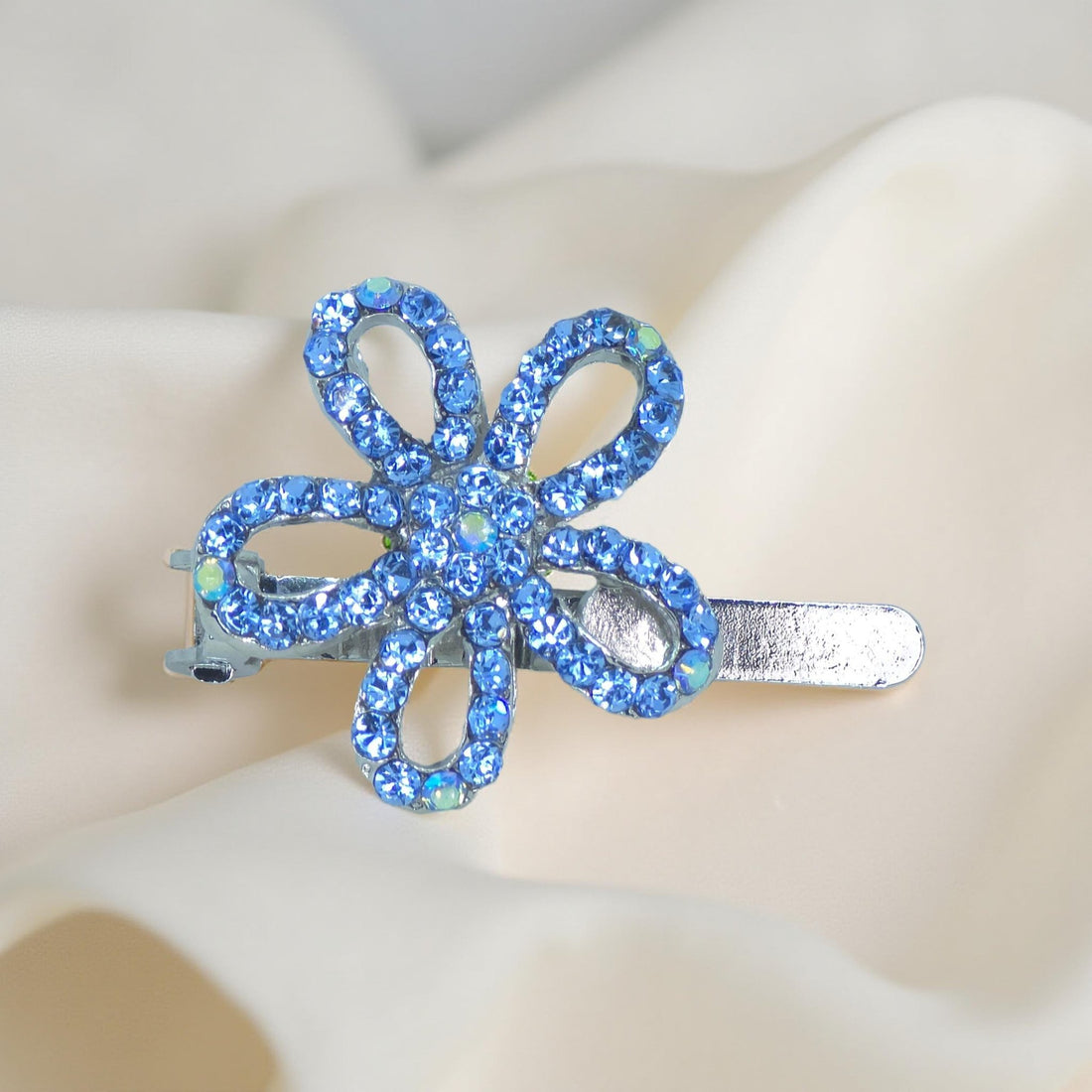 Haerime PetalMuse Magnetique in Blue – close-up of sapphire crystal petals placed on matte satin with subtle folds