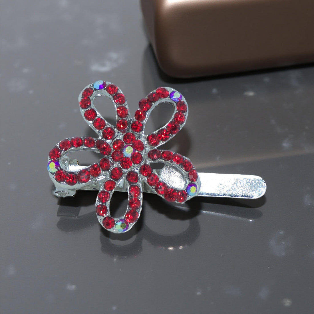 PHaerime PetalMuse Magnetique in Red – close-up showing deep red crystals and five-loop silhouette under natural lighting