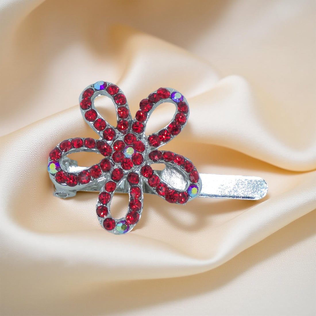 Haerime PetalMuse Magnetique in Red – ruby-toned mini flower clip shown on warm ivory satin with folded shadows