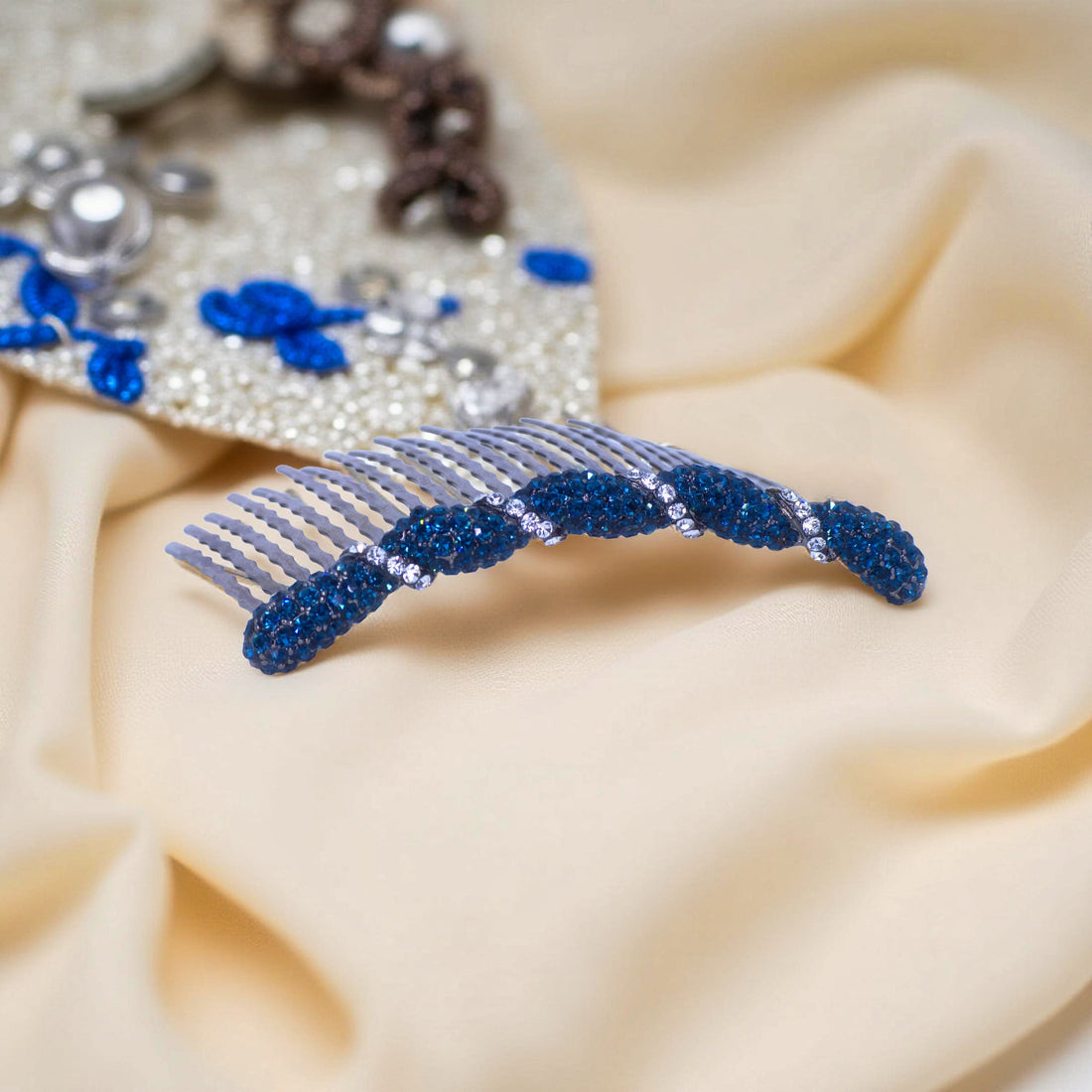 Haerime Seraphine Twist Comb in Navy – midnight blue crystal comb displayed on pearl white silk with gradient shadows