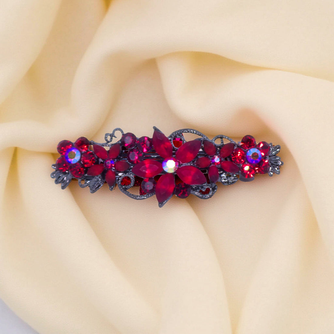 Haerime Serenbelle Bloom in Red – close-up showing garnet and ruby marquise petals atop warm velvet surface in soft ambient light