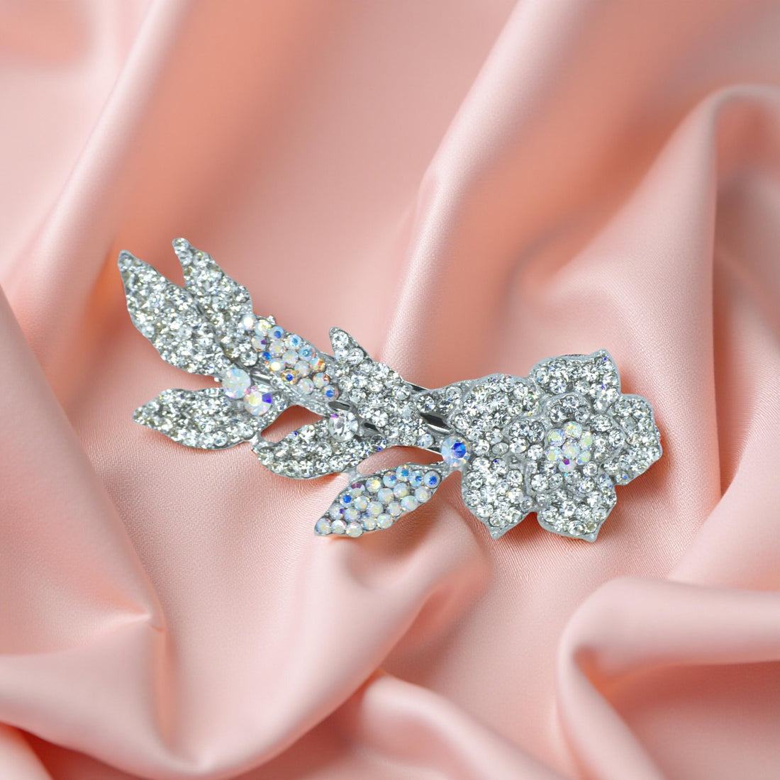 Haerime Twilight Bloom Mini in Clear – close-up of crystal bloom barrette with radiant petals on velvet display