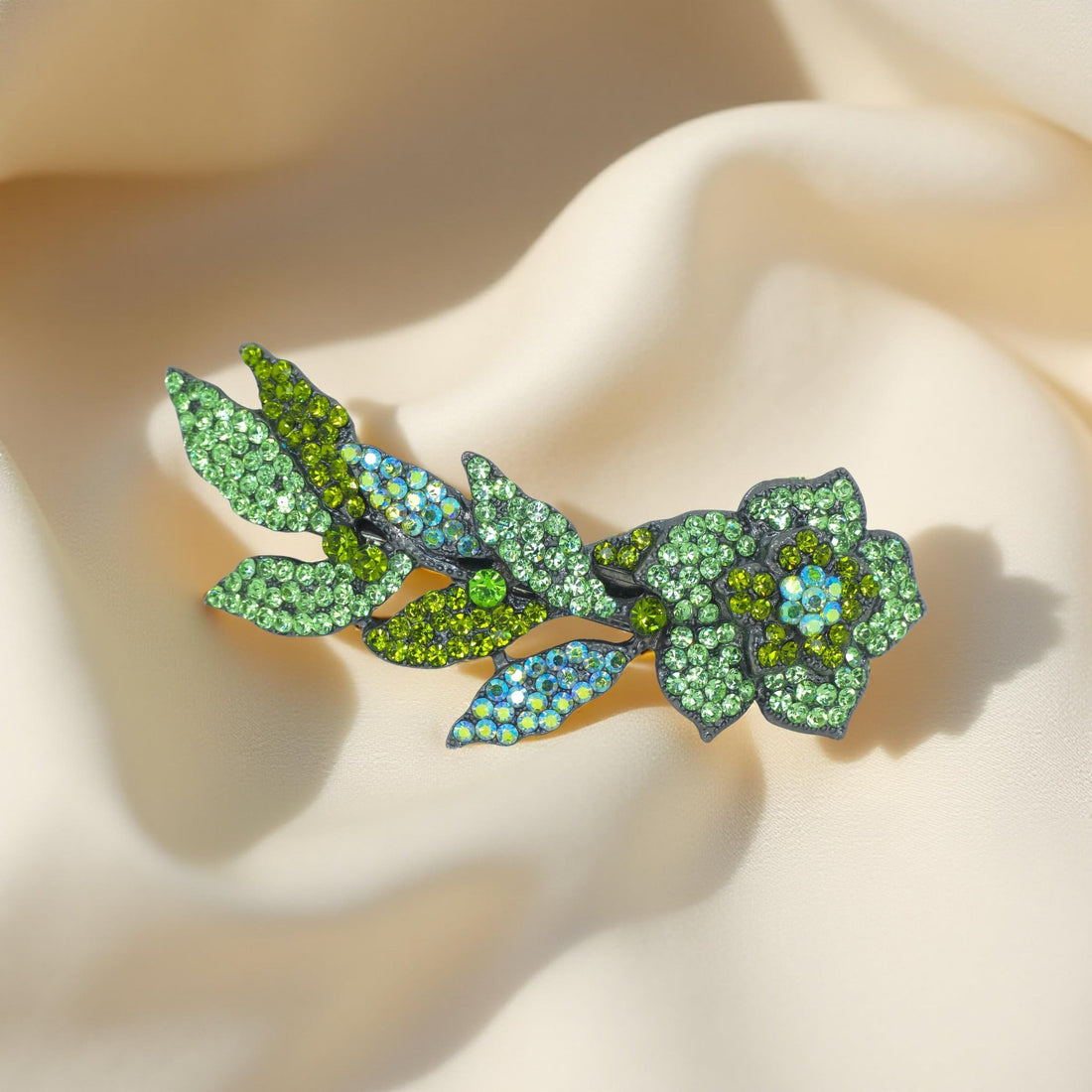 Haerime Twilight Bloom Mini in Peridot – crystal flower pin with olive and chartreuse petals on cream velvet