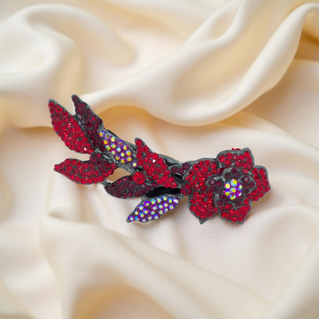 Haerime Twilight Bloom Mini in Red – angled floral barrette resting on matte rose-toned background with botanical depth