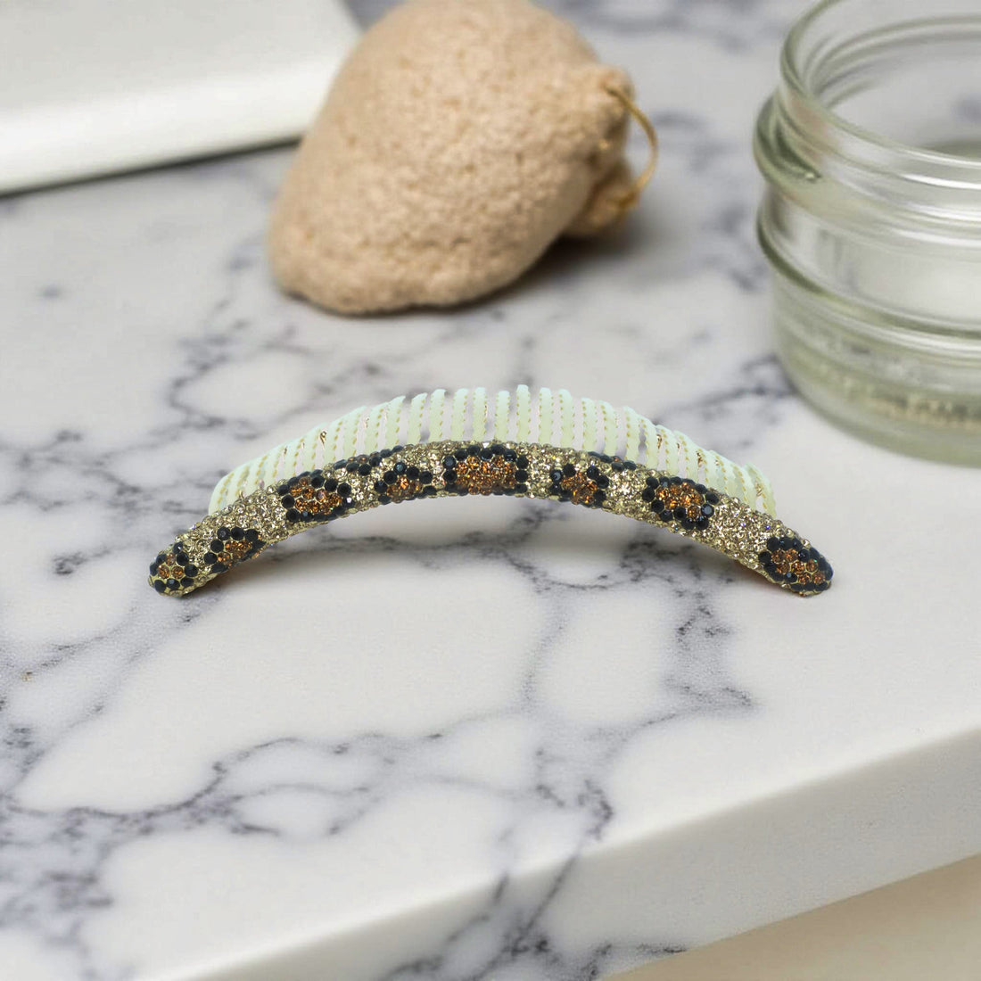 Haerime Velvette Arc in Golden Leopard – close-up showing mixed amber and black stones with curved teeth and resin finish