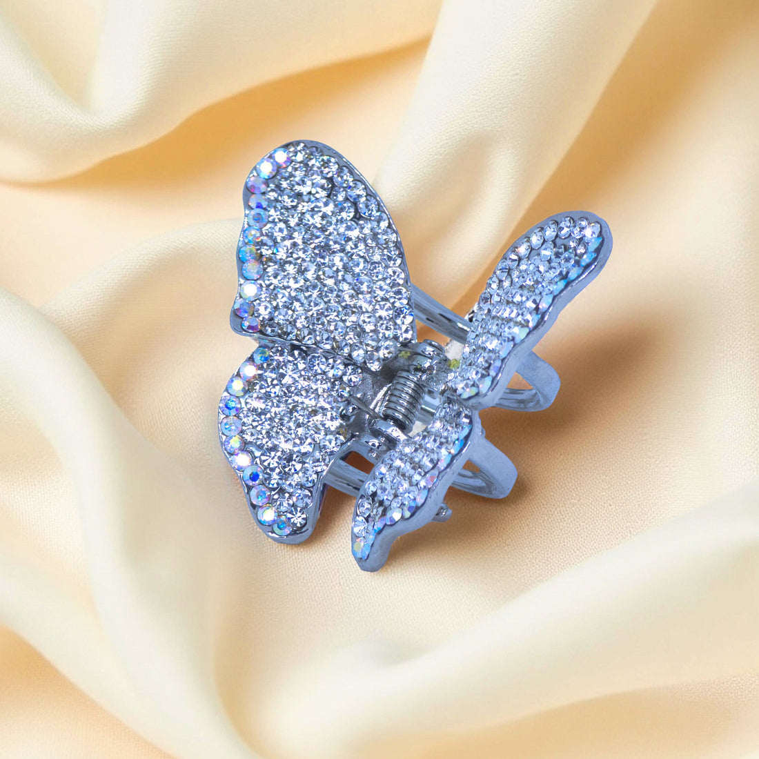 Haerime Papillora Mini Claw in Clear – macro view of shimmering white crystals over satin drape with light diffusion