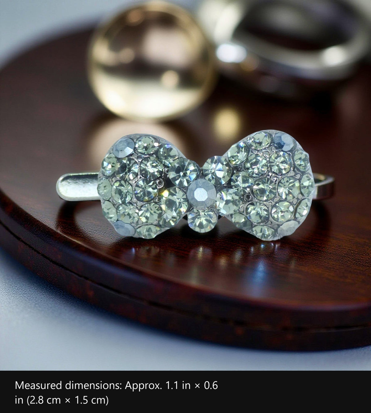 Chérie Mini Bow — Magnetic Hair Clip with measured dimensions marked: Approx. 1.1 in × 0.6 in (2.8 cm × 1.5 cm)