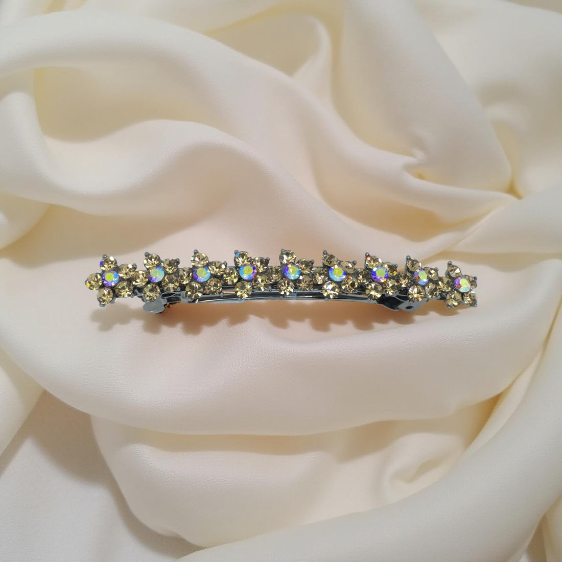 Amber version of Haerime Aureflor Arc – single-row floral barrette with hand-set rhinestones