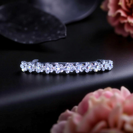 Haerime Blosselina Row Barrette in Clear – slimline floral crystal design shown on velvet background