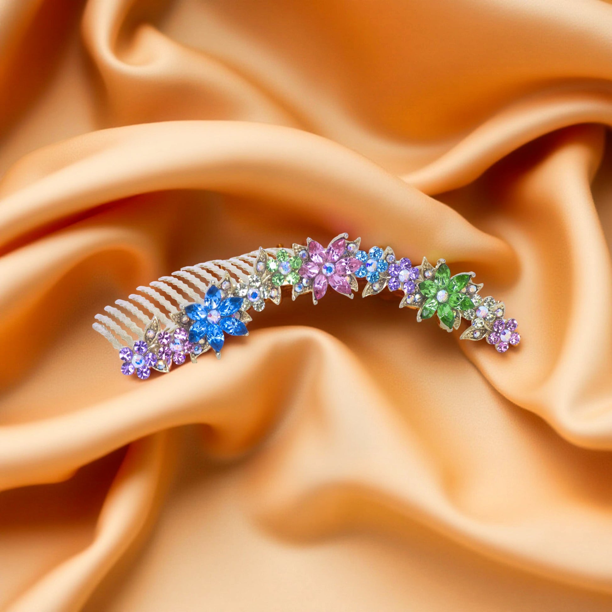 Haerime Celestara Crown Comb in Rainbow detail view – layered petal crystals and scroll base