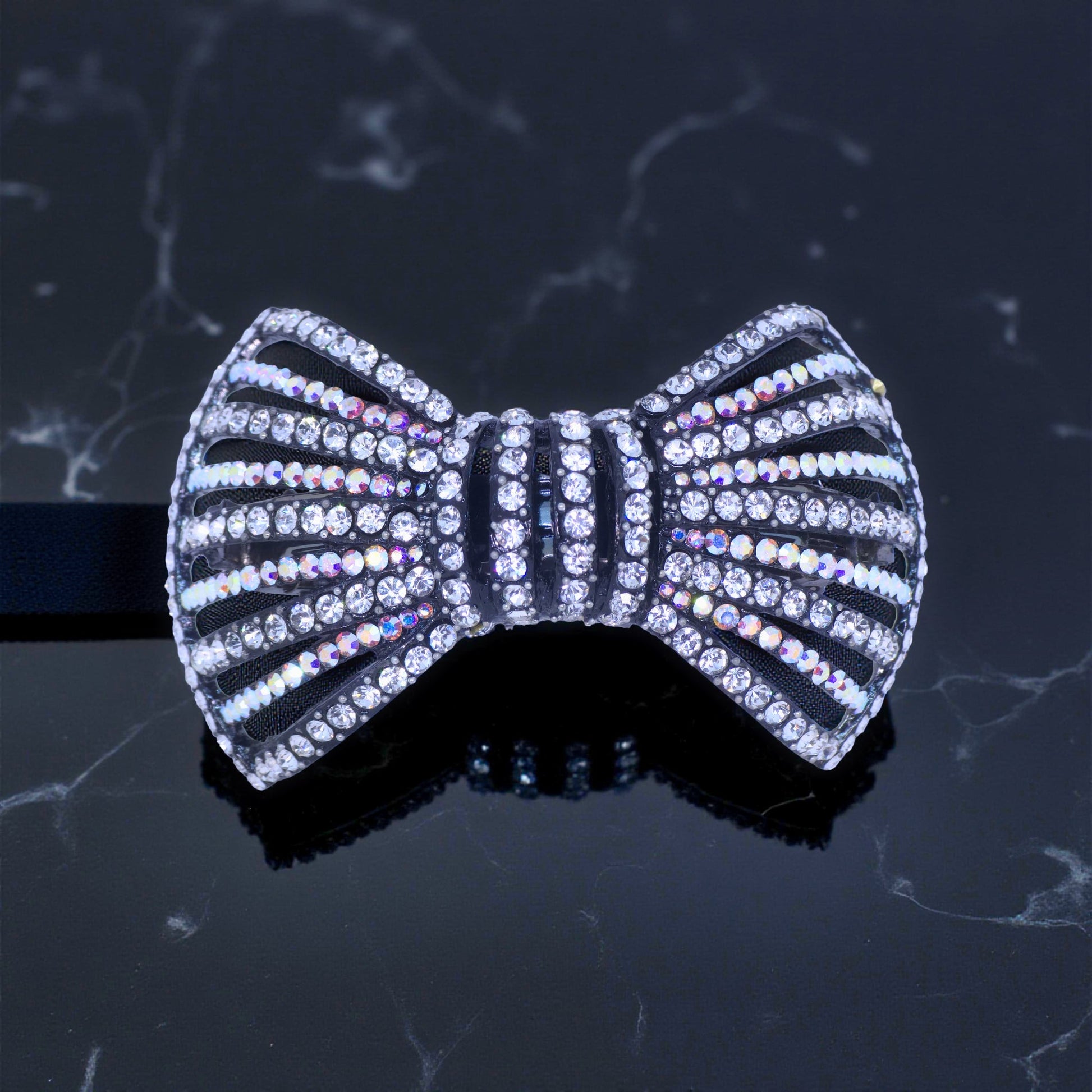 Haerime Celestial Ribbons Barrette in Clear – sculptural crystal bow barrette shown on velvet background

