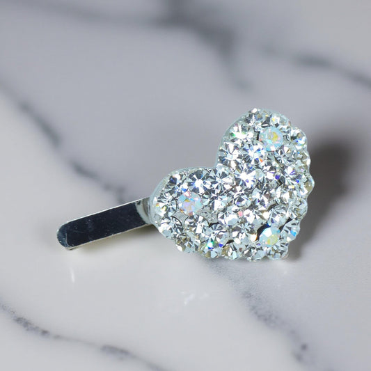 Haerime CoeurClip in Clear – crystal heart hair clip displayed on neutral canvas background with soft shadow