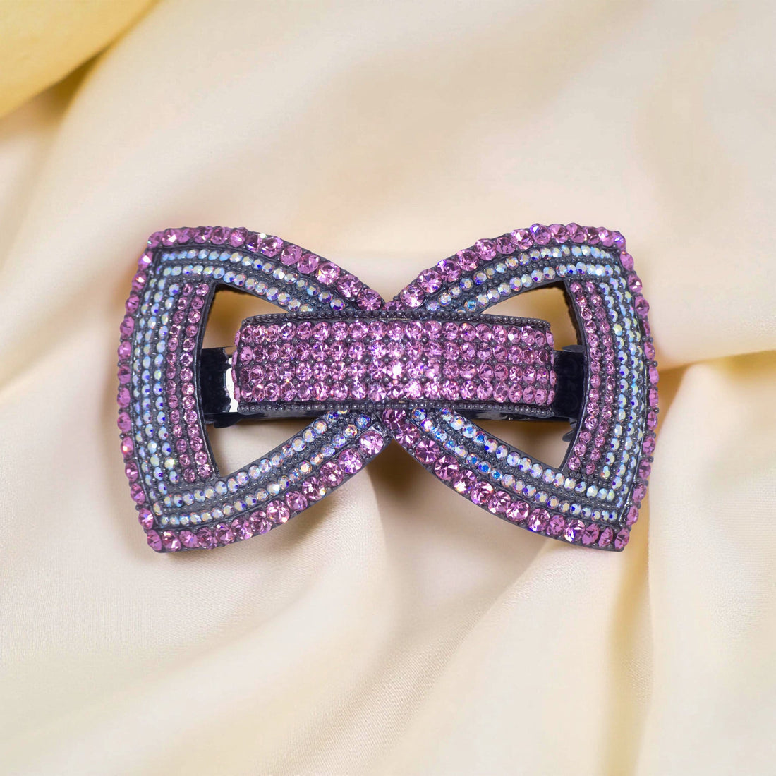 : Haerime Ecliptique Bow in Pink close-up – rose gloss enamel with pavé sparkle and structural arcs