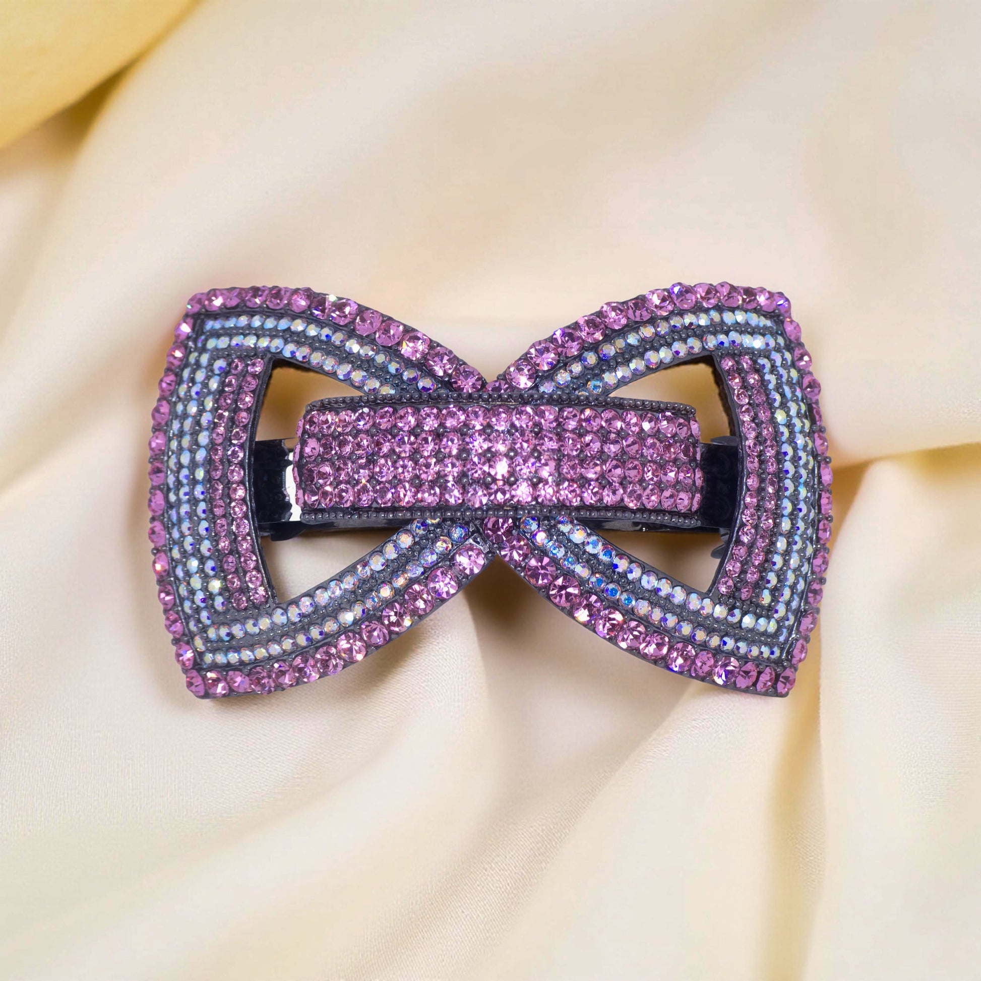 : Haerime Ecliptique Bow in Pink close-up – rose gloss enamel with pavé sparkle and structural arcs
