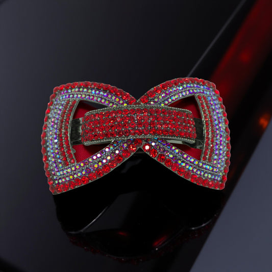 Haerime Ecliptique Bow Barrette in Red – crystal pavé double bow on glossy black lacquer background, studio-lit with bold highlight shadow