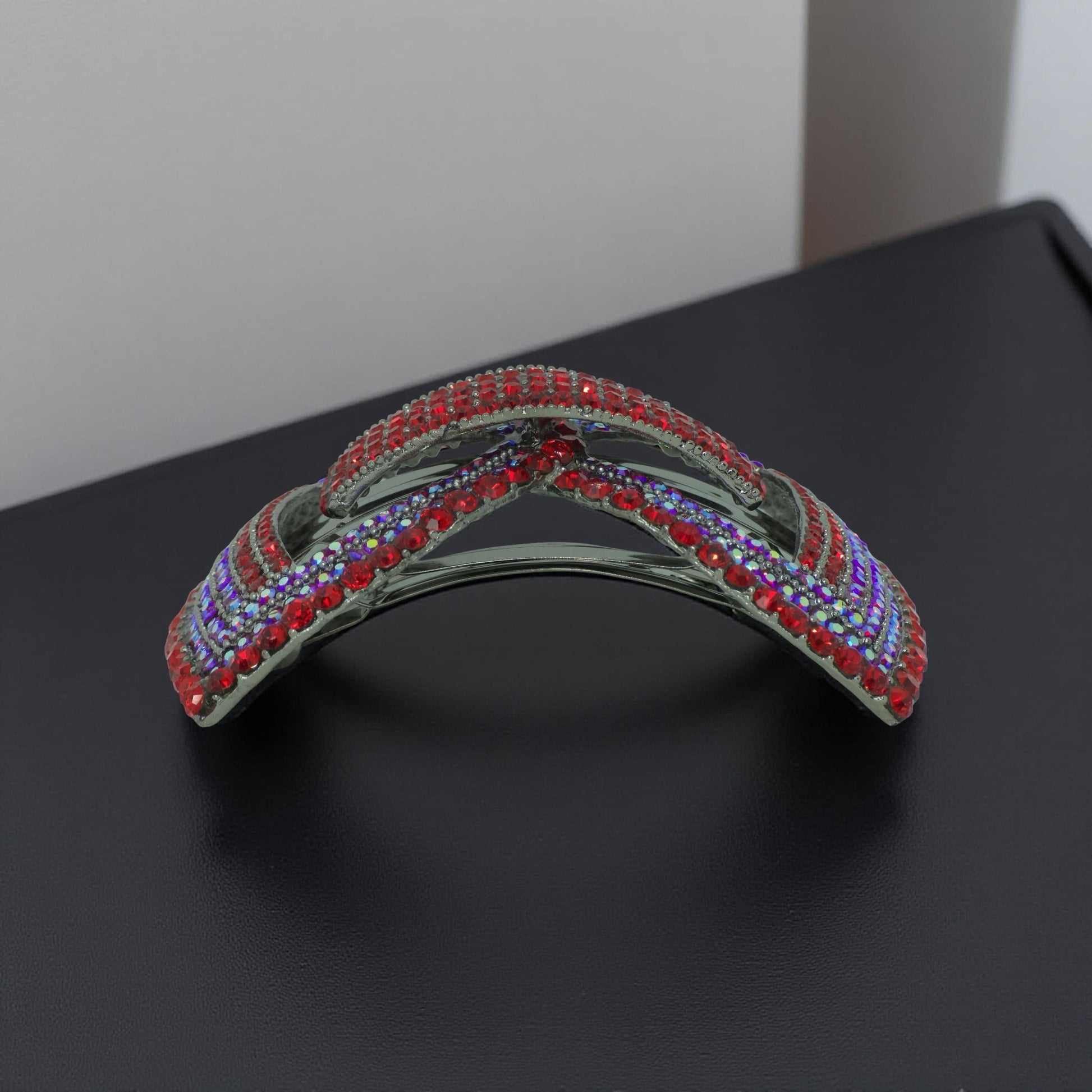 Horizontal side view of Haerime Ecliptique Bow in Red – dimensional bow arcs and symmetry on neutral satin backdrop